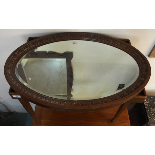 75 - A Victorian mahogany framed bevelled glass wall mirror, another Victorian oak oval framed bevelled g... 