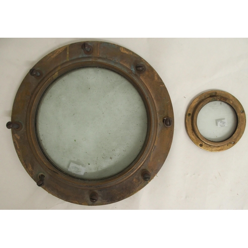 76 - A 20th century brass porthole window, 38cm diameter and another smaller brass porthole window, 15cm ... 