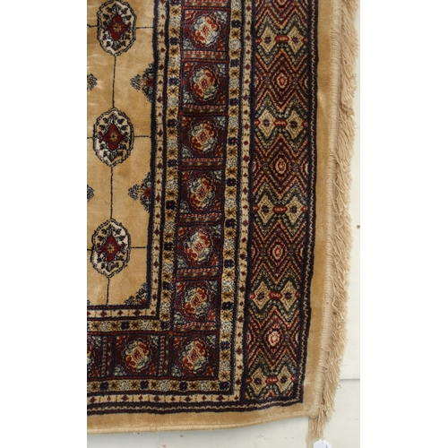 81 - A cream ground Kashmiri rug with all over lozenge design and multicoloured borders, 168cm long x 116... 