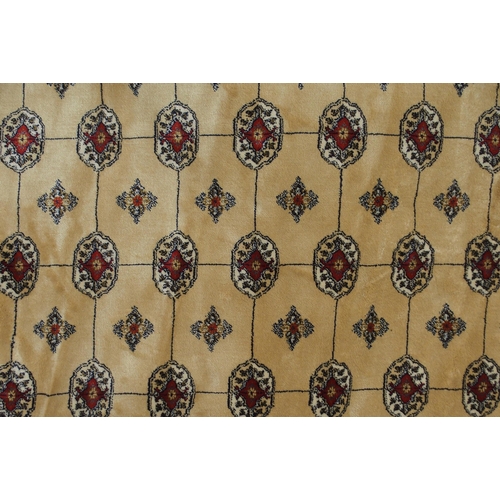 81 - A cream ground Kashmiri rug with all over lozenge design and multicoloured borders, 168cm long x 116... 