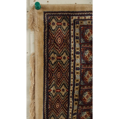 81 - A cream ground Kashmiri rug with all over lozenge design and multicoloured borders, 168cm long x 116... 