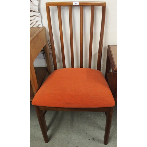 83 - A mid 20th century teak two tier occasional table and a pair of G Plan dining chairs (3)