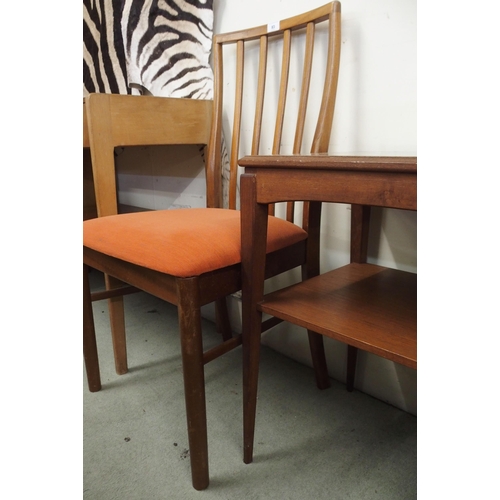 83 - A mid 20th century teak two tier occasional table and a pair of G Plan dining chairs (3)