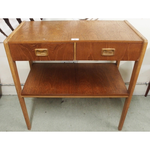 85 - A mid 20th century teak Scandinavian style two tier table with two drawers with shaped drawer pulls,... 