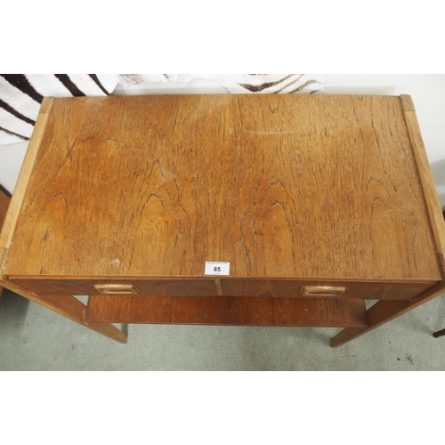 85 - A mid 20th century teak Scandinavian style two tier table with two drawers with shaped drawer pulls,... 