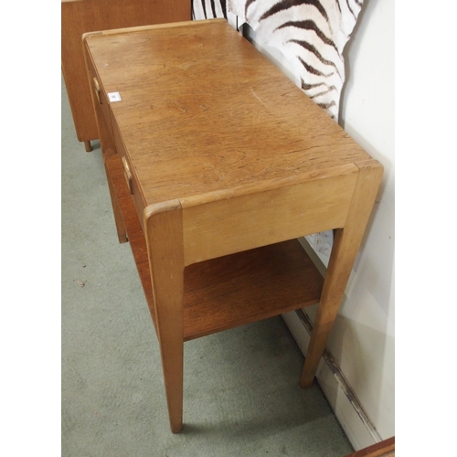 85 - A mid 20th century teak Scandinavian style two tier table with two drawers with shaped drawer pulls,... 