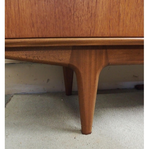 86 - A mid 20th century teak A.H. McIntosh of Kirkcaldy sideboard with pair of cabinet doors by three dra... 