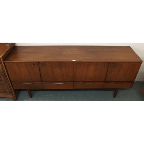 90 - A mid 20th century stained teak Portwood sideboard with two pairs of cabinet doors over four drawers... 