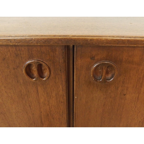 90 - A mid 20th century stained teak Portwood sideboard with two pairs of cabinet doors over four drawers... 