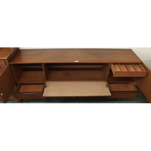 90 - A mid 20th century stained teak Portwood sideboard with two pairs of cabinet doors over four drawers... 