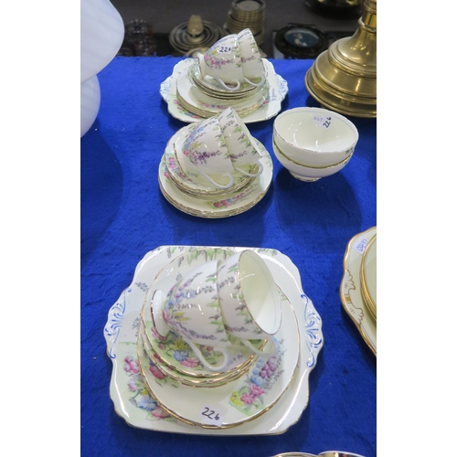 226 - A Foley China Hollyhocks pattern tea set comprising six cups, twelve saucers and plates, two cake pl... 