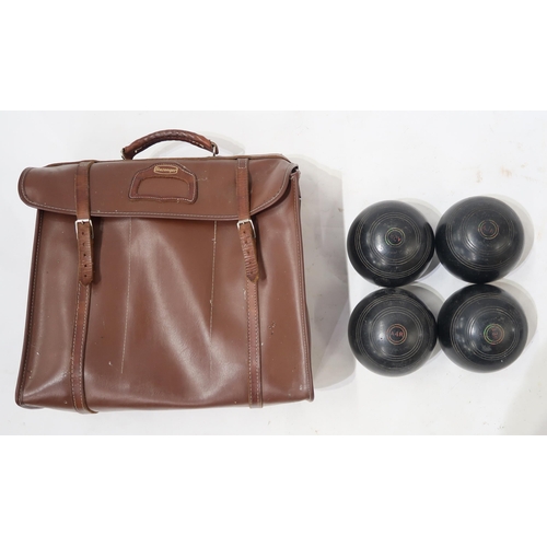 417 - A set of four lawn bowls, in a Slazenger vinyl carry-case