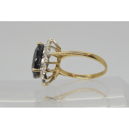 603 - A 9ct gold sapphire and diamond accent cluster ring, size J1/2, weight 3.2gms 