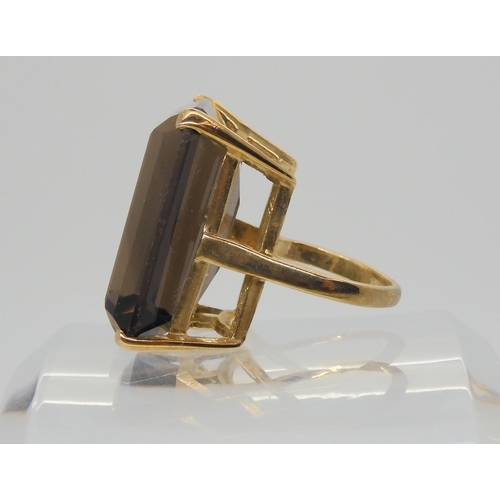 604 - A 9ct gold ring set with a very large smoky quartz, 2.5cm x 1.7cm, finger size approx J, weight 12.4... 