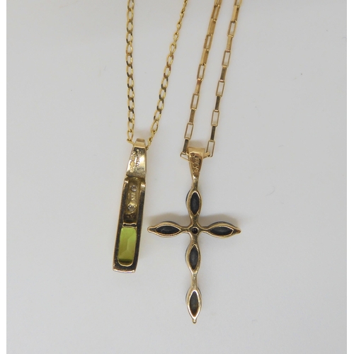 628 - A sapphire and diamond accent cross pendant, a peridot and diamond pendant, both with chains, a yell... 