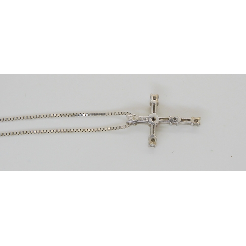 635 - An 18ct white gold baguette and brilliant cut diamond cross, set with estimated approx 0.35cts of di... 