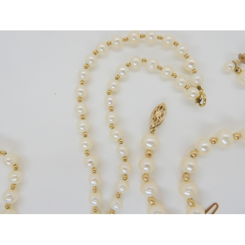 638 - A string of pearls with interspaced gold beads and a 9ct clasp, with matching bracelet and earrings,... 