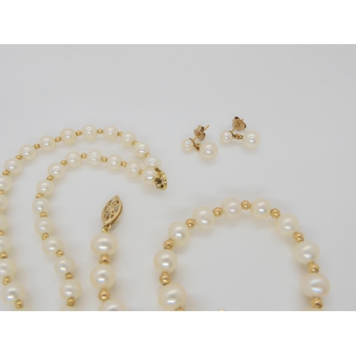 638 - A string of pearls with interspaced gold beads and a 9ct clasp, with matching bracelet and earrings,... 