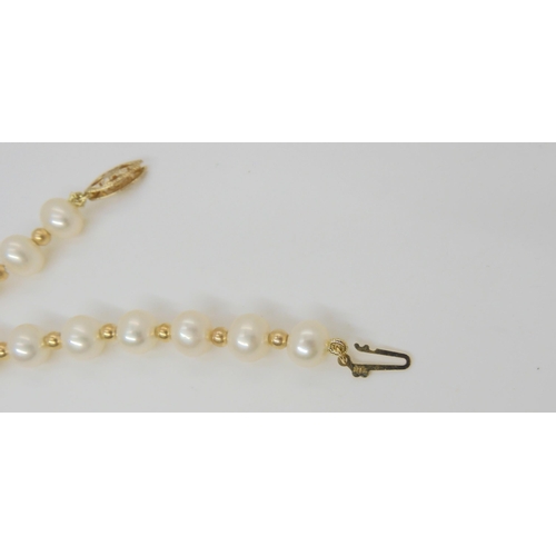 638 - A string of pearls with interspaced gold beads and a 9ct clasp, with matching bracelet and earrings,... 