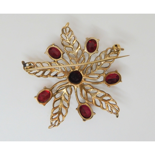 641 - A 9ct gold red gem set flower brooch, diameter 5cm, weight 11gms