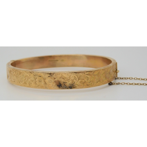 642 - A 9ct gold bangle with foliate engraving, weight 10.9gms