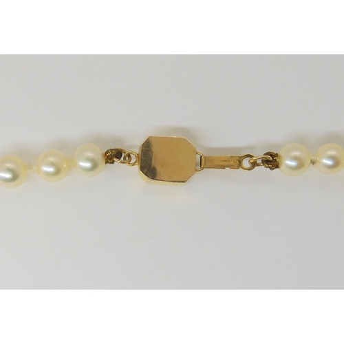 651 - A long string of good quality pearls with a 14k gold, Chinese symbol pattern clasp. Each pearl appro... 