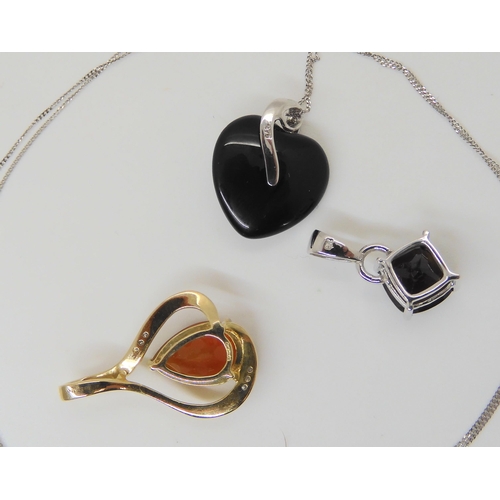 654 - Three 9ct gems set pendants, onyx heart set with diamond accents on a 9ct white gold chain, a fire o... 