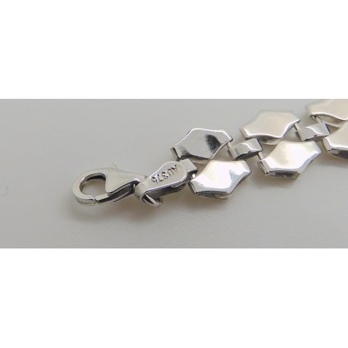 658 - A 9ct white gold champagne diamond line bracelet, set with estimated approx 1ct of brilliant cuts, t... 