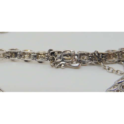 658 - A 9ct white gold champagne diamond line bracelet, set with estimated approx 1ct of brilliant cuts, t... 