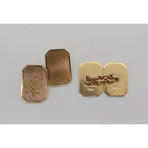 673 - A pair of 9ct gold cufflinks, with monogram and engine turned engraved design. Weight 6.6gms