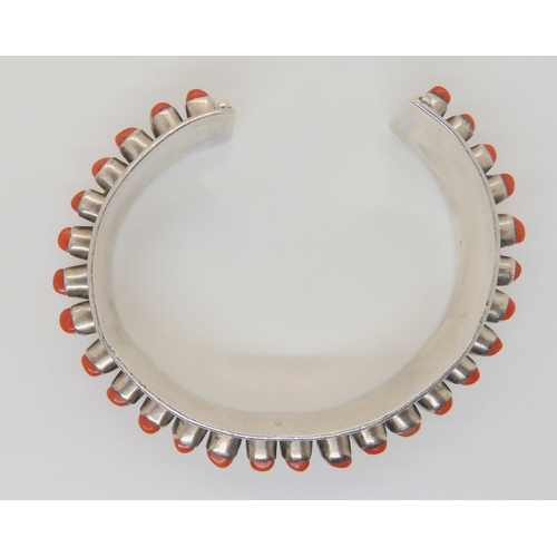 683 - A silver coral set bangle