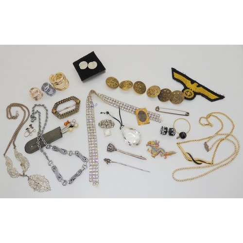 685B - A gilded white metal hummingbird feather embellished dragon brooch, a Nazi cloth badge and a collect... 