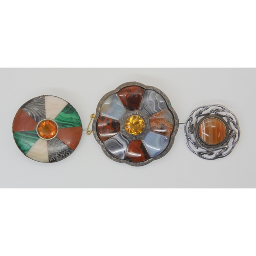 687B - Two white metal Scottish agate and fossil inlaid brooches, and a further silver example set with car... 