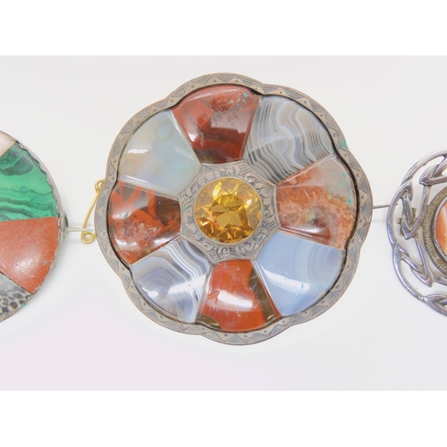 687B - Two white metal Scottish agate and fossil inlaid brooches, and a further silver example set with car... 