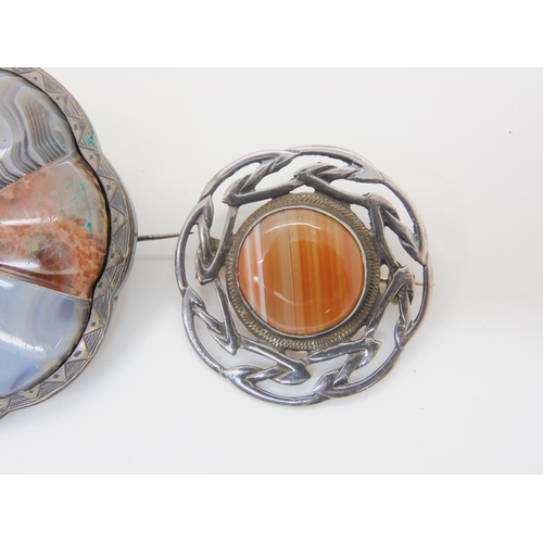 687B - Two white metal Scottish agate and fossil inlaid brooches, and a further silver example set with car... 