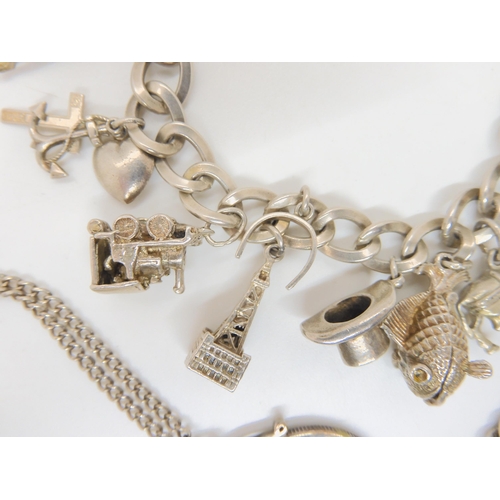 683B - Two silver charm bracelets hung with silver and white metal charms and a 1964 Half Dollar coin on ch... 