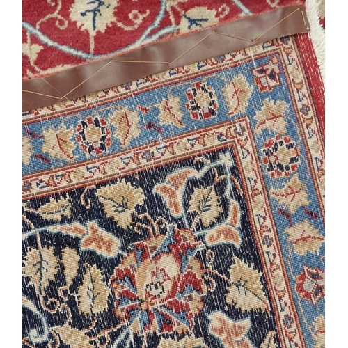 2141 - A RED GROUND KESHAN RUGwith blue central medallion, matching spandrels and dark blue border, 373cm l... 