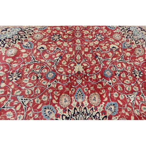 2141 - A RED GROUND KESHAN RUGwith blue central medallion, matching spandrels and dark blue border, 373cm l... 