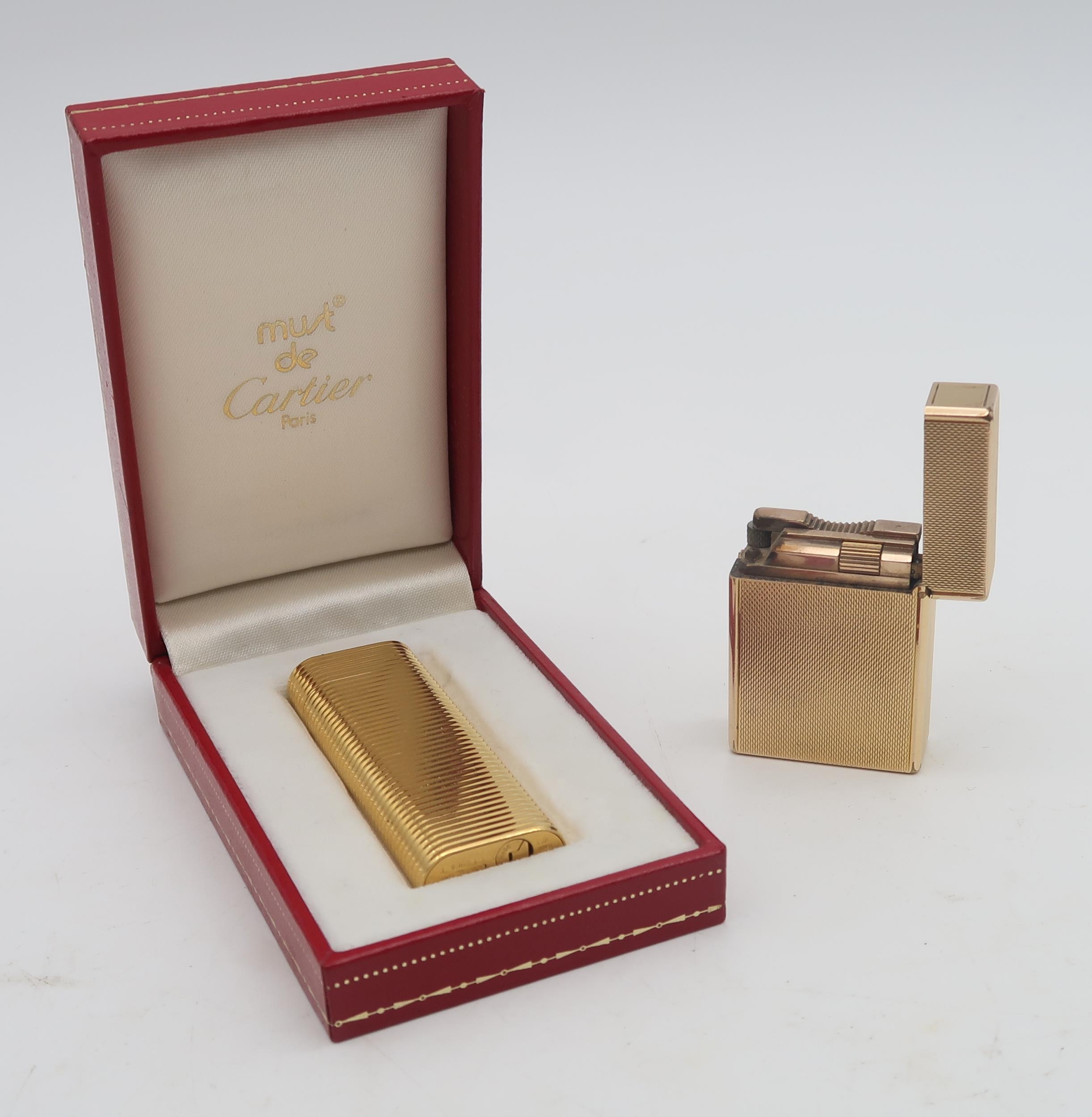 A boxed Cartier Plaque d Or cigarette lighter the lid engraved