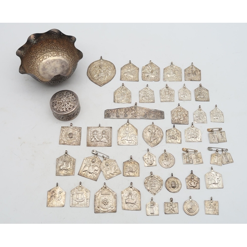 478 - A collection of Indian white metal wares, including a quantity of embossed medallions with accompany... 