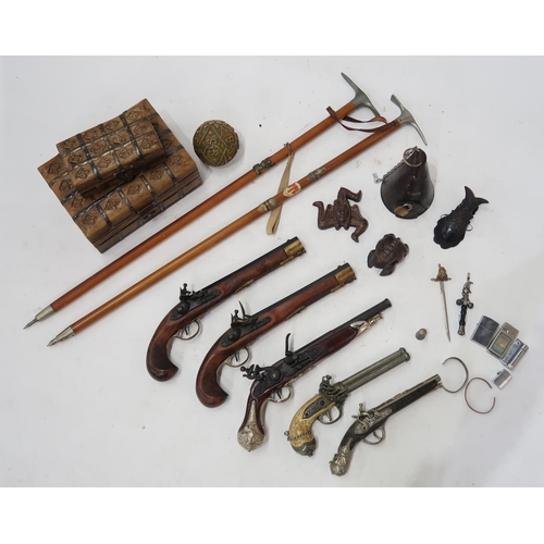 509 - A mixed lot, to include various replica flintlock pistols, souvenir mountaineering axes, a conical l... 