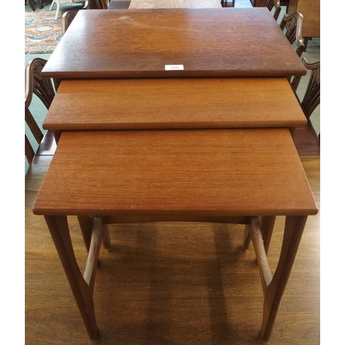 110 - A mid 20th century teak nest of three tables with shaped stretchered supports, 51cm high x 57cm wide... 