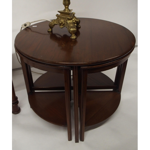 116 - A 20th century mahogany circular nesting table, table scales and a brass and ceramic table lamp (3)