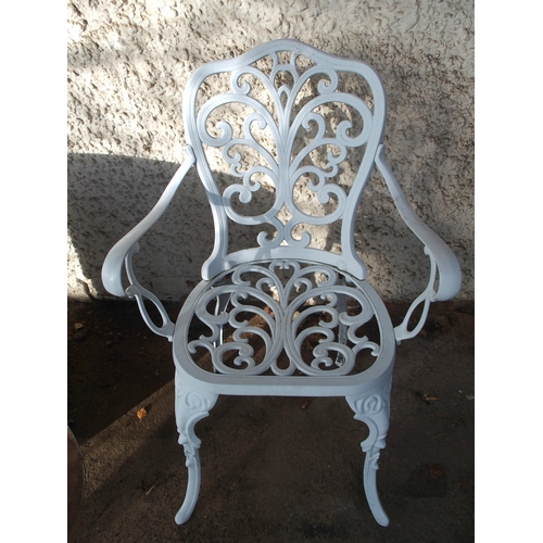 124 - A 20th century white painted cast metal garden table and two chairs (3)