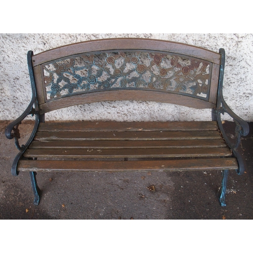 125 - An early 20th century garden bench with cast ends and cast floral splat insert, 87cm high x 127cm wi... 