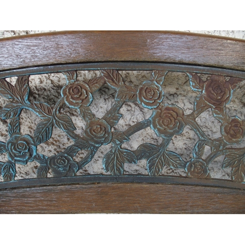 125 - An early 20th century garden bench with cast ends and cast floral splat insert, 87cm high x 127cm wi... 