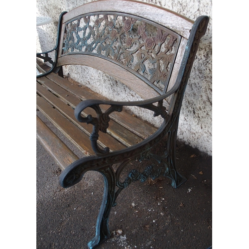 125 - An early 20th century garden bench with cast ends and cast floral splat insert, 87cm high x 127cm wi... 