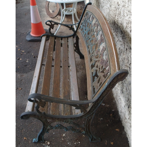 125 - An early 20th century garden bench with cast ends and cast floral splat insert, 87cm high x 127cm wi... 