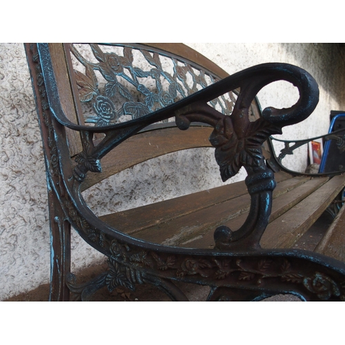 125 - An early 20th century garden bench with cast ends and cast floral splat insert, 87cm high x 127cm wi... 