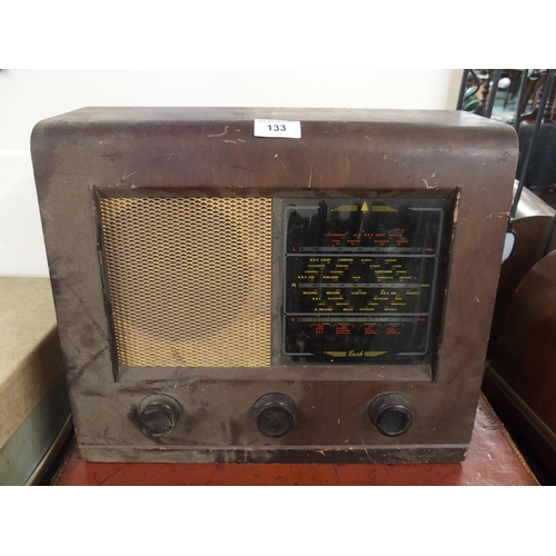 133 - A 20th century mahogany cased Bush radio, portable Singer sewing machine, leather suitcase and a 20t... 